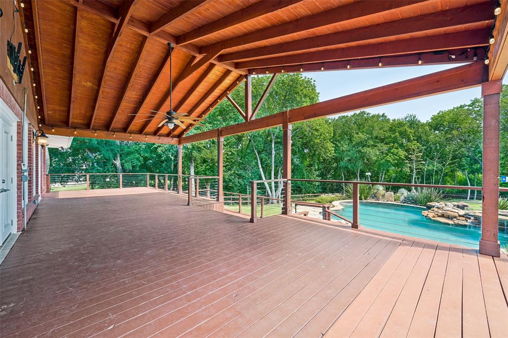 9 Country Ridge Road Melissa, TX 75454 - Photo 28 of 37 Huge Deck or Porch on the back is partially covered and overlooks the pool and waterfalls.