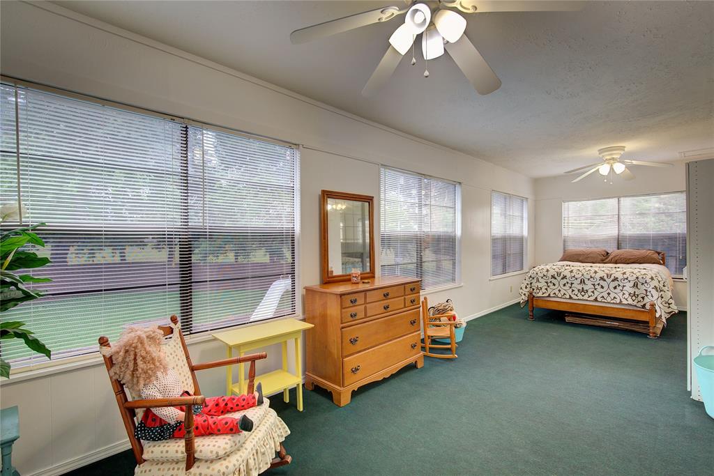 753 County Rd SW 3110 Mount Vernon, TX 75457 - Photo 25 of 40 This huge sunroom off of the primary upstairs suite, has tons of windows, ceiling fan, separate Ac unit. Could be a play room, solarium, or guest bedroom.