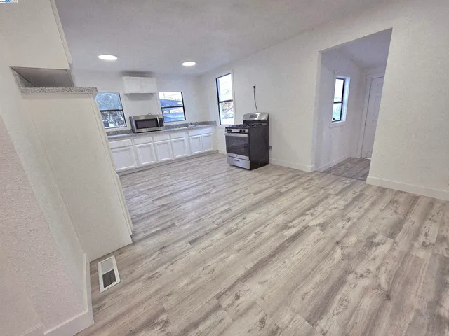 a view of a kitchen with a sink and a refrigerator