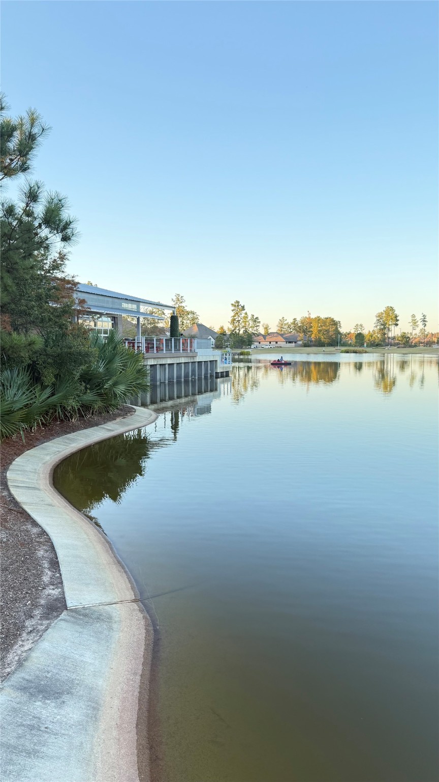 15707 Autumn Sun Court Conroe, TX 77302 - Photo 12 of 13 a view of a lake with houses in the back