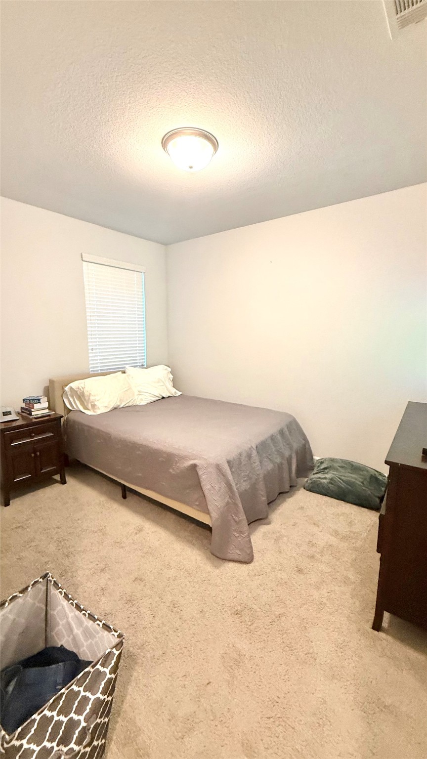 15707 Autumn Sun Court Conroe, TX 77302 - Photo 5 of 13 a bedroom with a bed and a couch