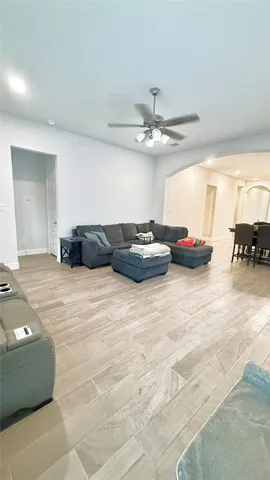 a living room with furniture and a chandelier