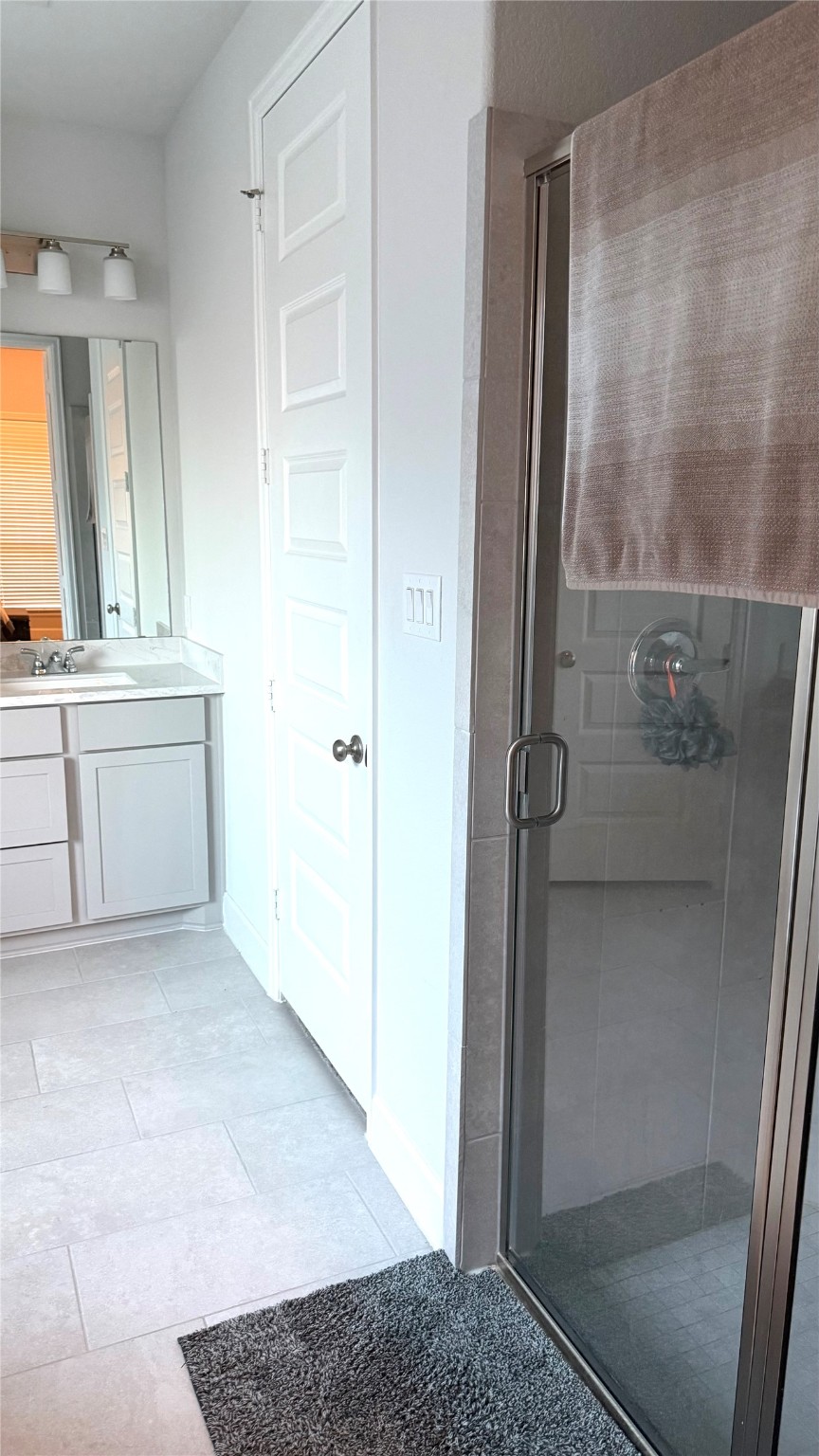 15707 Autumn Sun Court Conroe, TX 77302 - Photo 10 of 13 a bathroom with a granite countertop sink a mirror and a shower