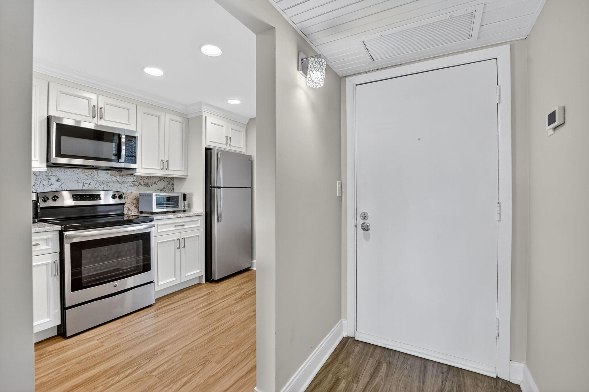 4 Royal Palm Way, Unit 3020 Boca Raton, FL 33432 - Photo 11 of 38 a kitchen with a refrigerator stove and microwave