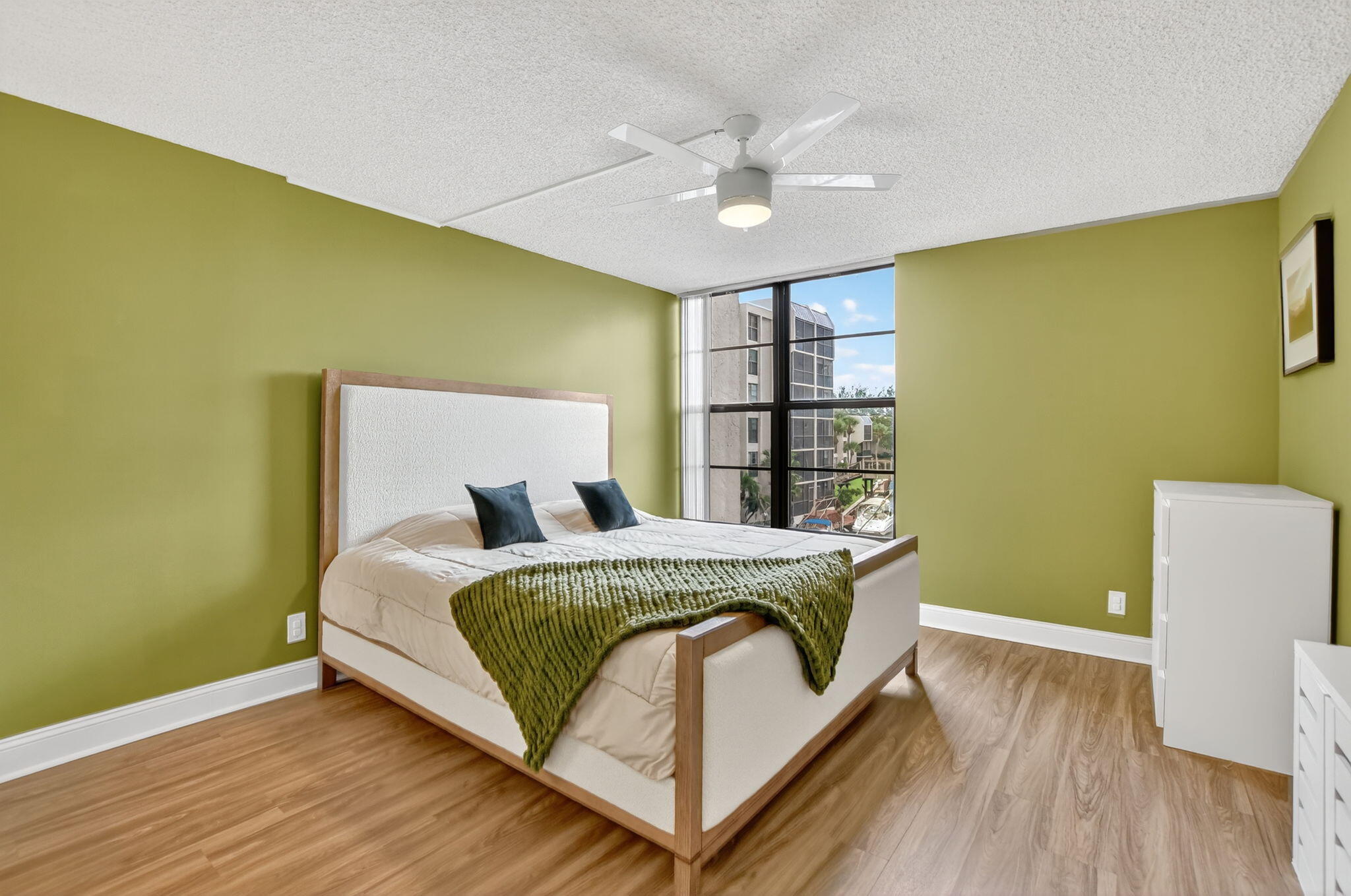 4 Royal Palm Way, Unit 3020 Boca Raton, FL 33432 - Photo 12 of 38 a bedroom with a bed and a chandelier