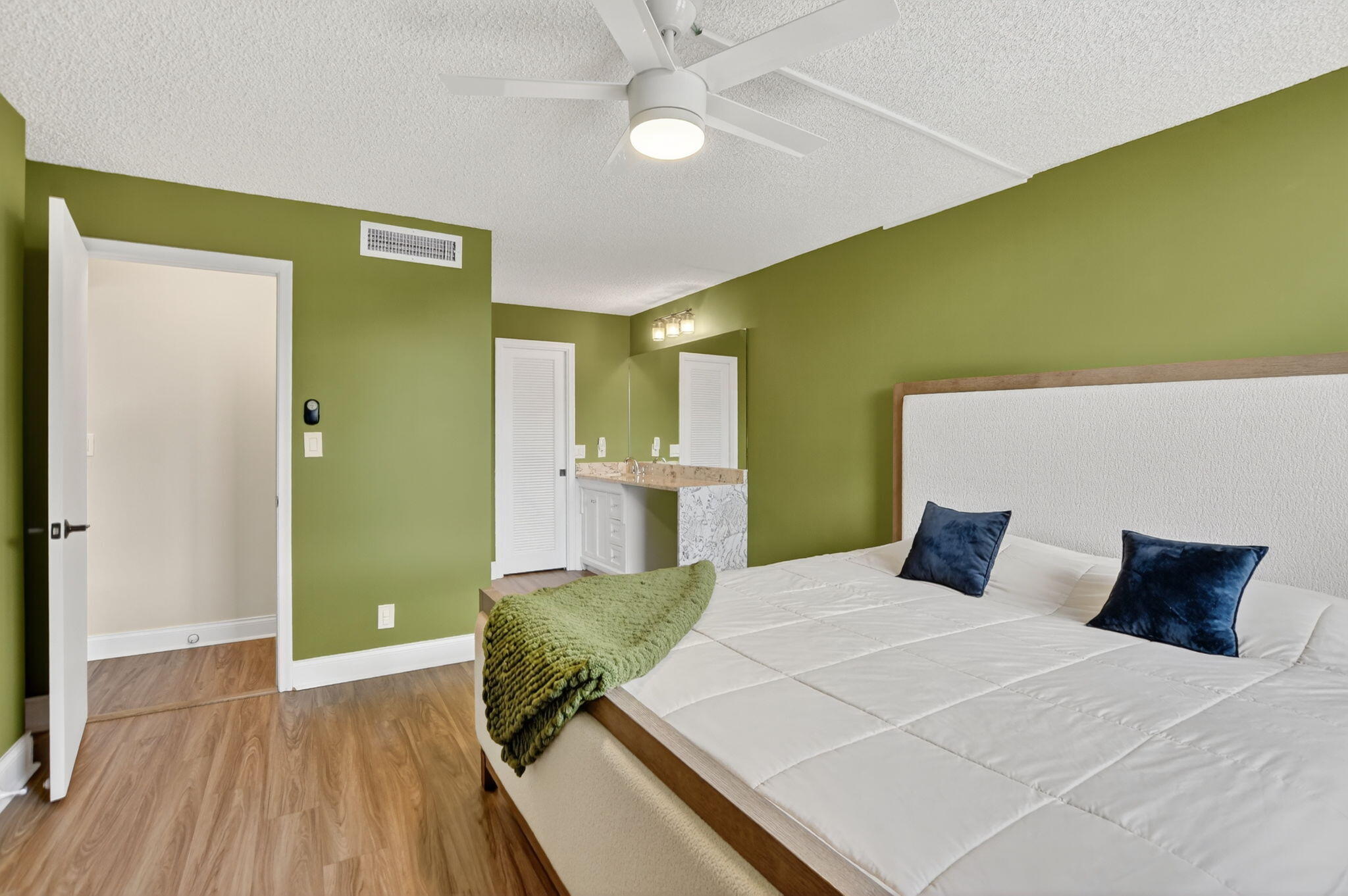 4 Royal Palm Way, Unit 3020 Boca Raton, FL 33432 - Photo 14 of 38 a bedroom with a bed and wooden floor