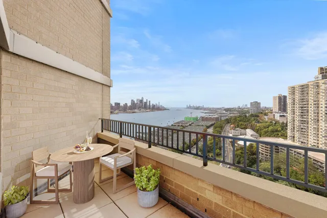 a view of a balcony with chairs and wooden floor