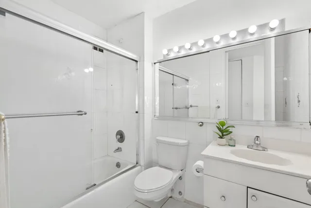 a bathroom with a sink a toilet a shower and a mirror