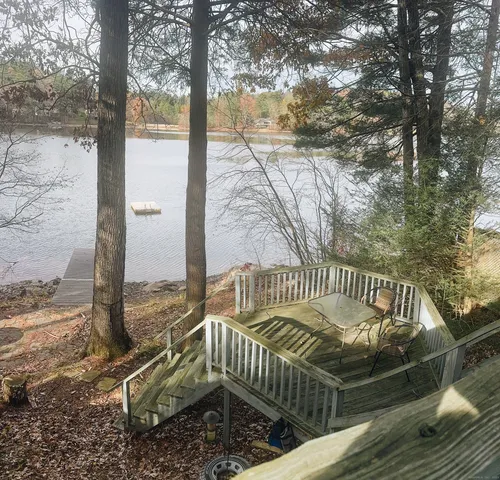 a view of balcony with wooden floor and fence