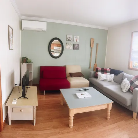 a living room with furniture and a wooden floor