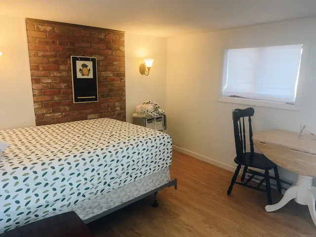 a bedroom with a bed and a chair