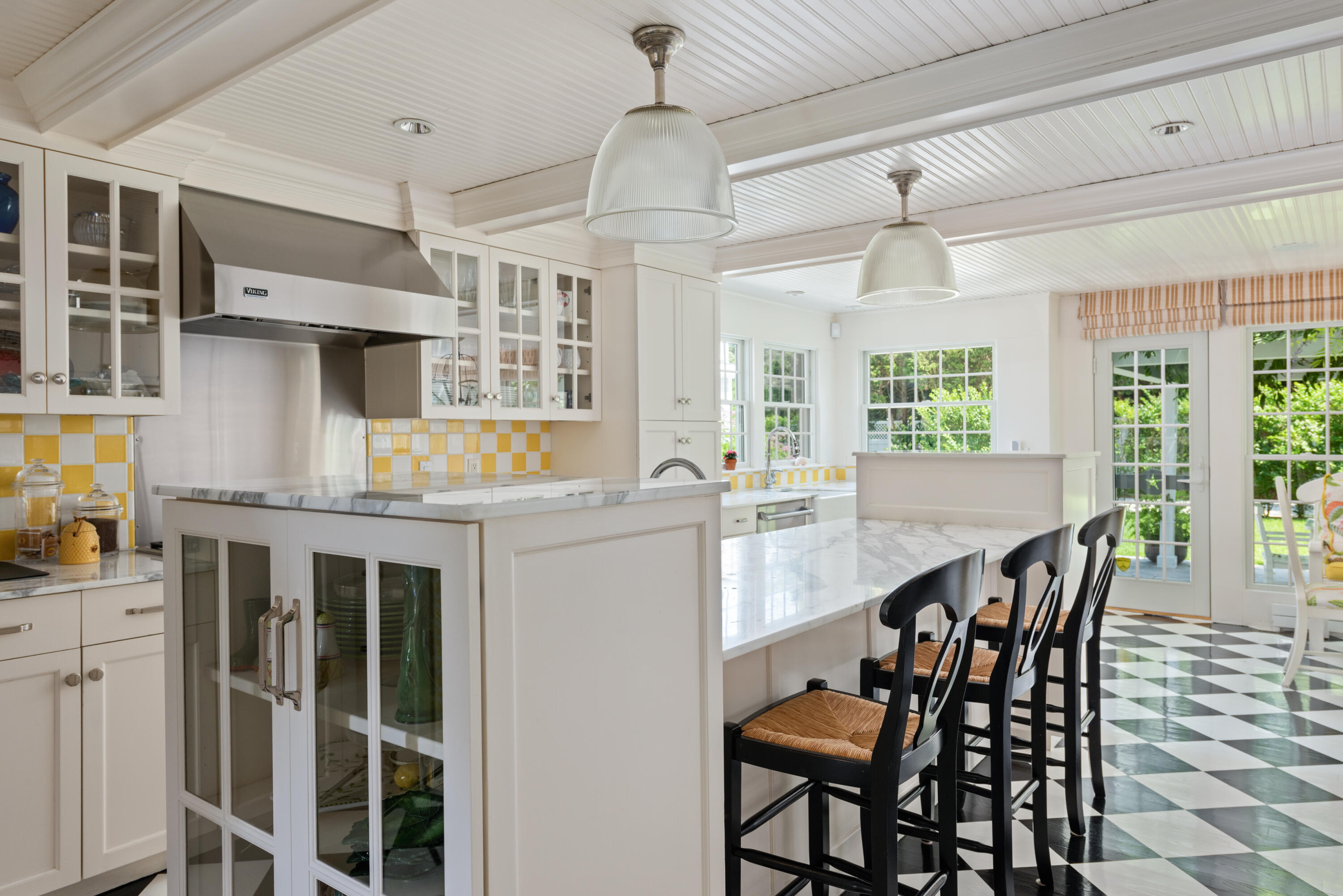32 Dunes Road Harwich Port, MA 02646 - Photo 15 of 56 a open kitchen with stainless steel appliances granite countertop a kitchen island a stove a table and chairs in it