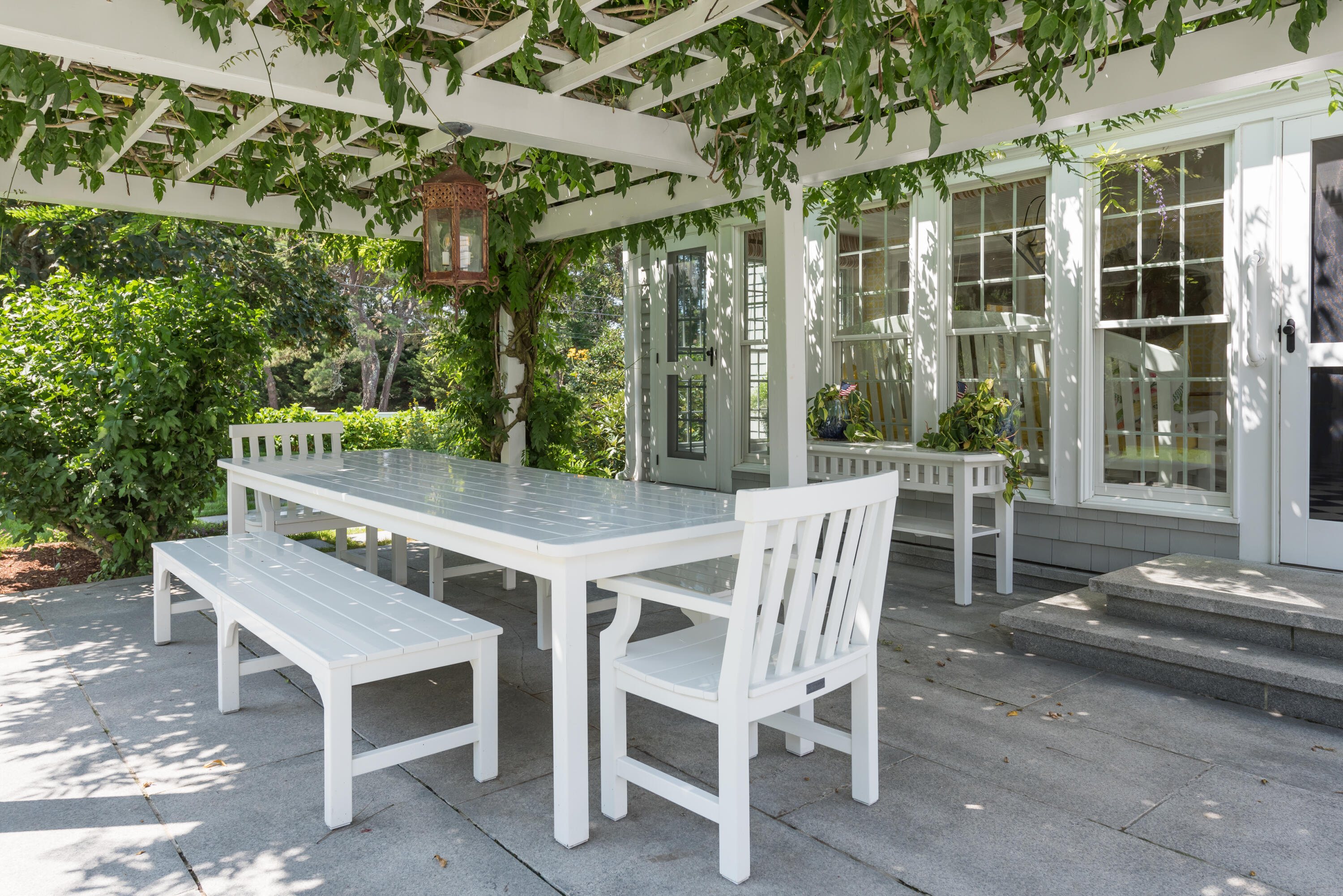 32 Dunes Road Harwich Port, MA 02646 - Photo 17 of 56 a view of a patio with a table and chairs and potted plants
