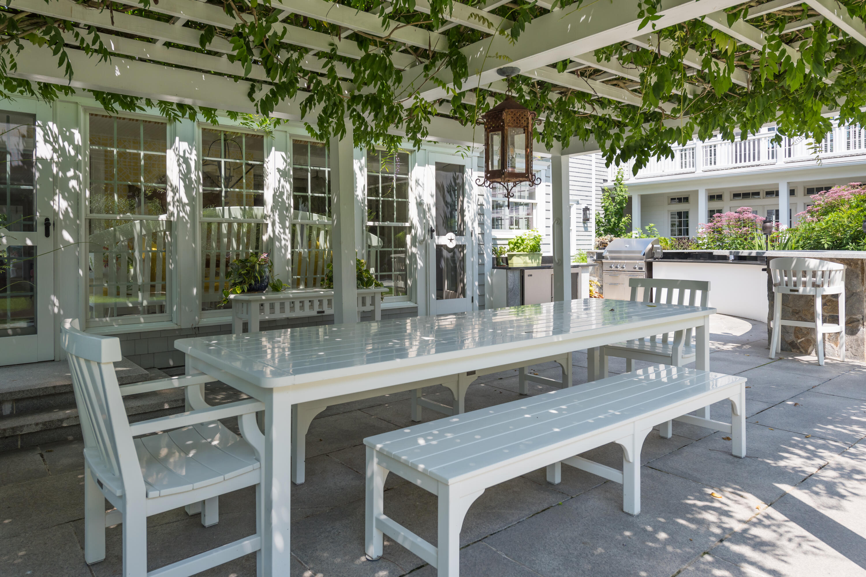 32 Dunes Road Harwich Port, MA 02646 - Photo 19 of 56 a view of a patio with table and chairs with wooden floor and fence