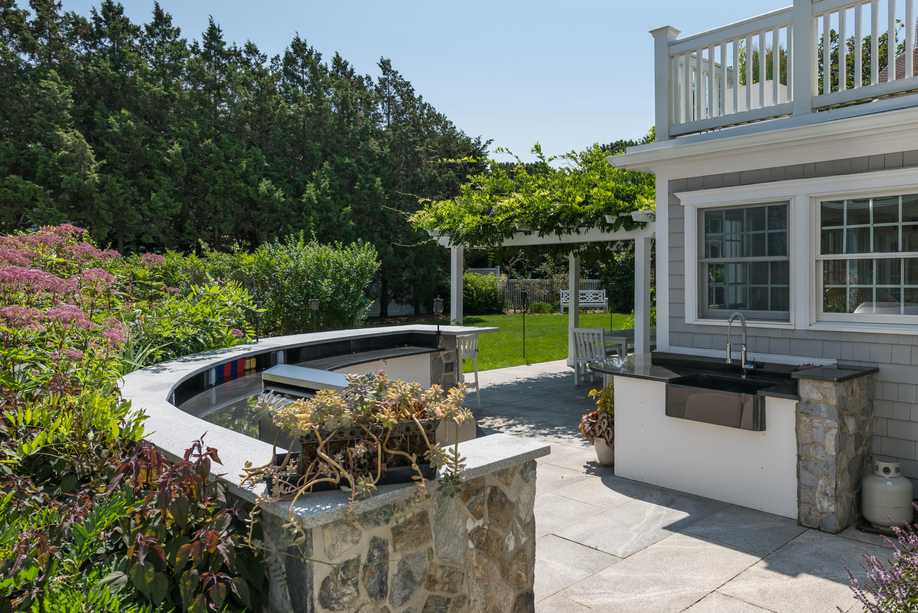 32 Dunes Road Harwich Port, MA 02646 - Photo 21 of 56 a view of a two chair and tables in the back yard of the house