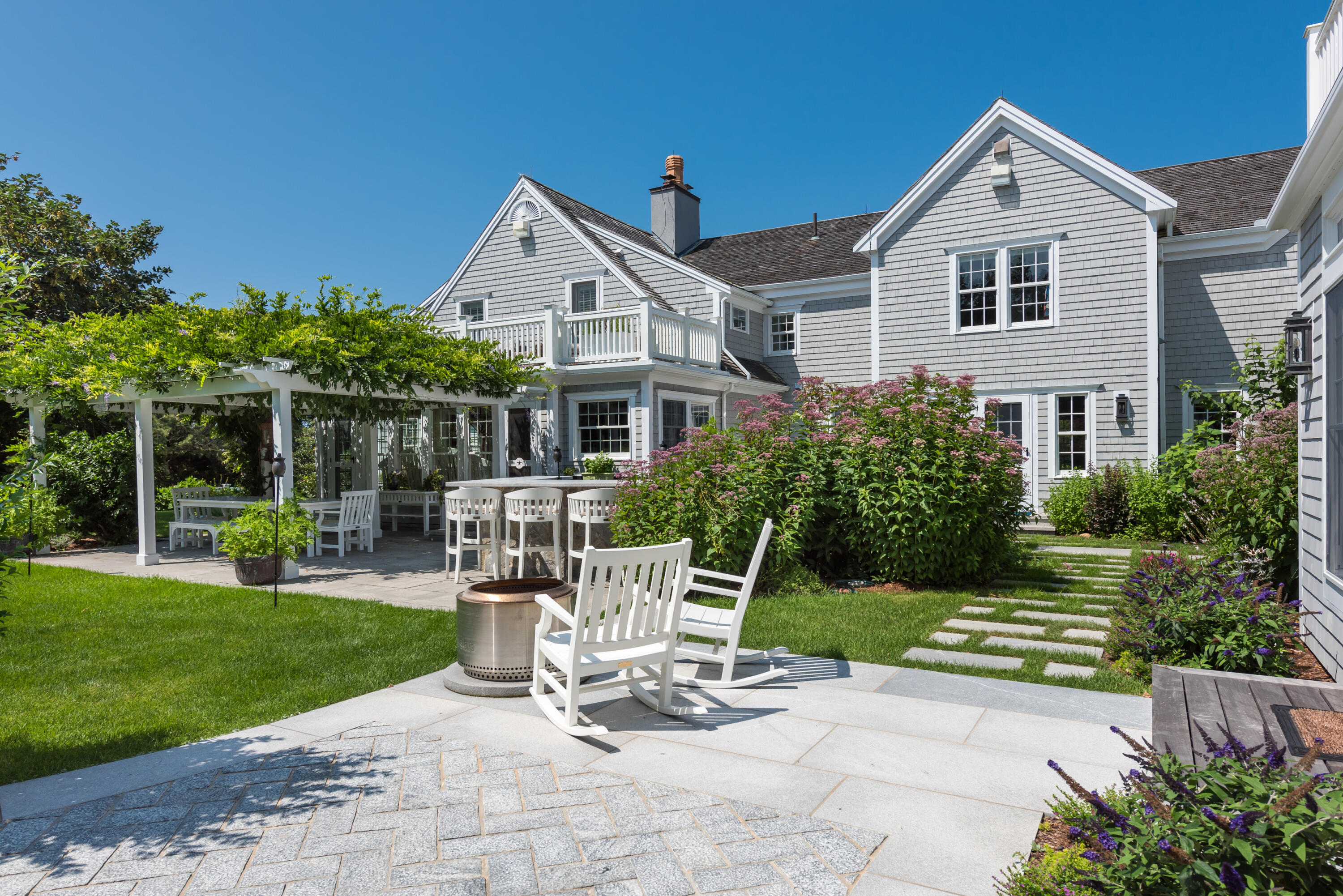 32 Dunes Road Harwich Port, MA 02646 - Photo 22 of 56 a view of a chair and table in backyard of the house
