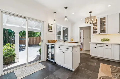 a kitchen with cabinets stainless steel appliances and wooden floor