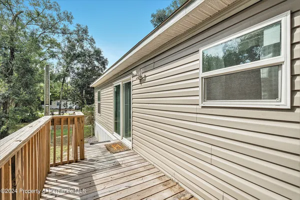 a view of balcony with wooden floor and fence