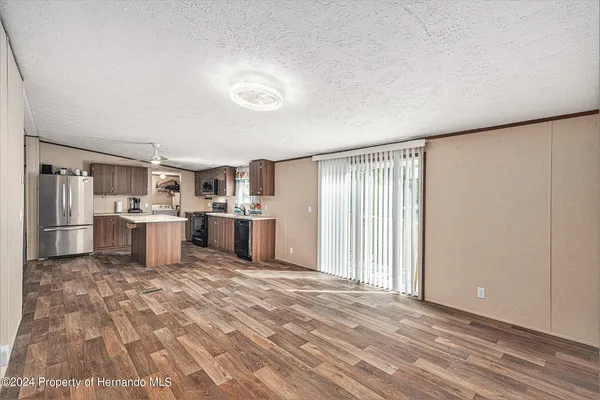 a view of a kitchen with furniture and empty room