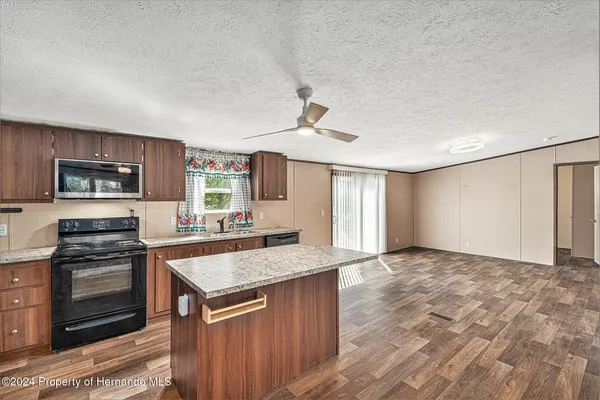 a view of livingroom with kitchen island furniture and flat screen tv