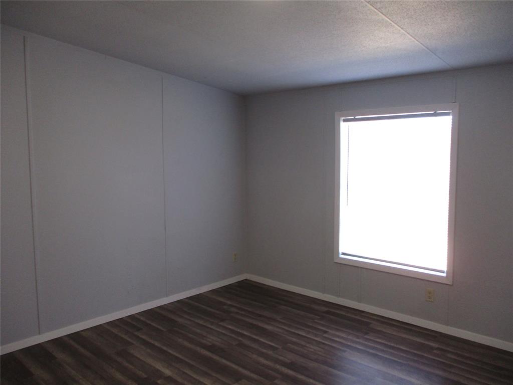 1336 Rains County Road 1530 Point, TX 75472 - Photo 15 of 26 an empty room with wooden floor and windows