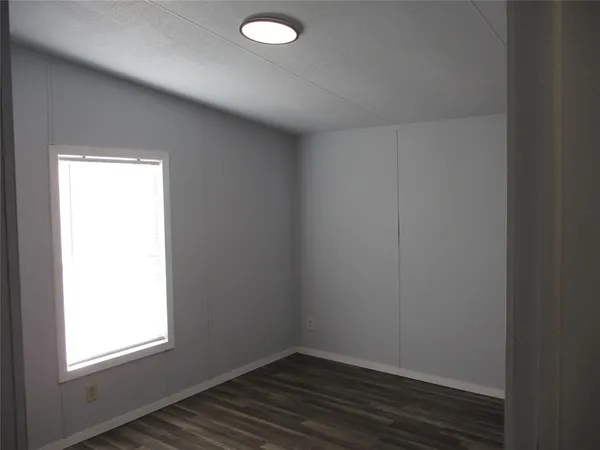 a bathroom with a toilet and a shower curtain