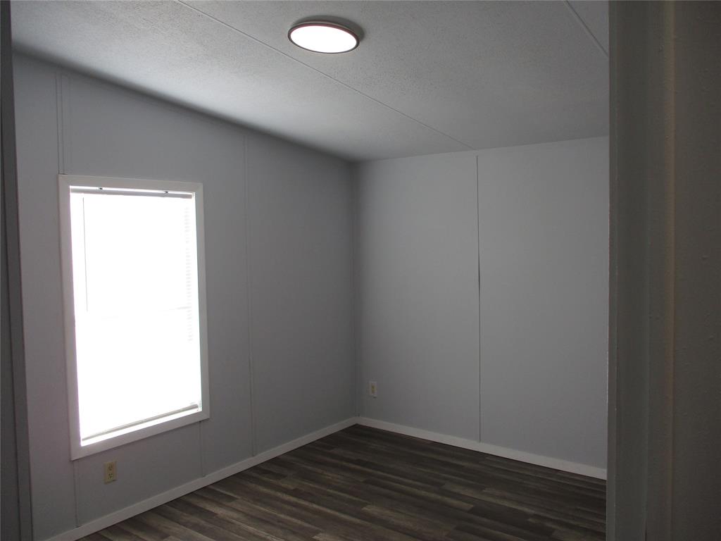 1336 Rains County Road 1530 Point, TX 75472 - Photo 23 of 26 an empty room with wooden floor and windows