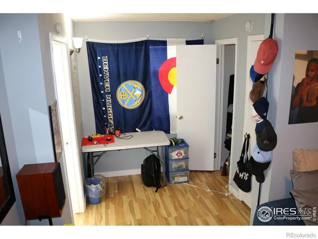 a living room with a table and a refrigerator