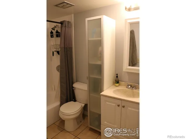 a bathroom with a toilet a sink and shower