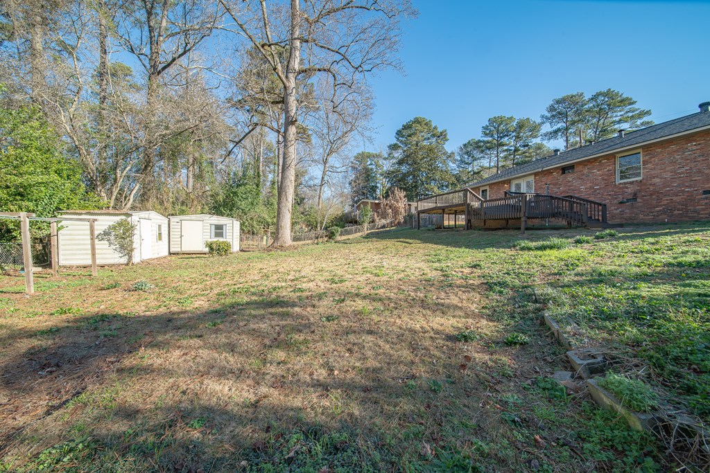 6411 Michael Avenue Columbus, GA 31909 - Photo 9 of 34 a view of a backyard with plants and a tree