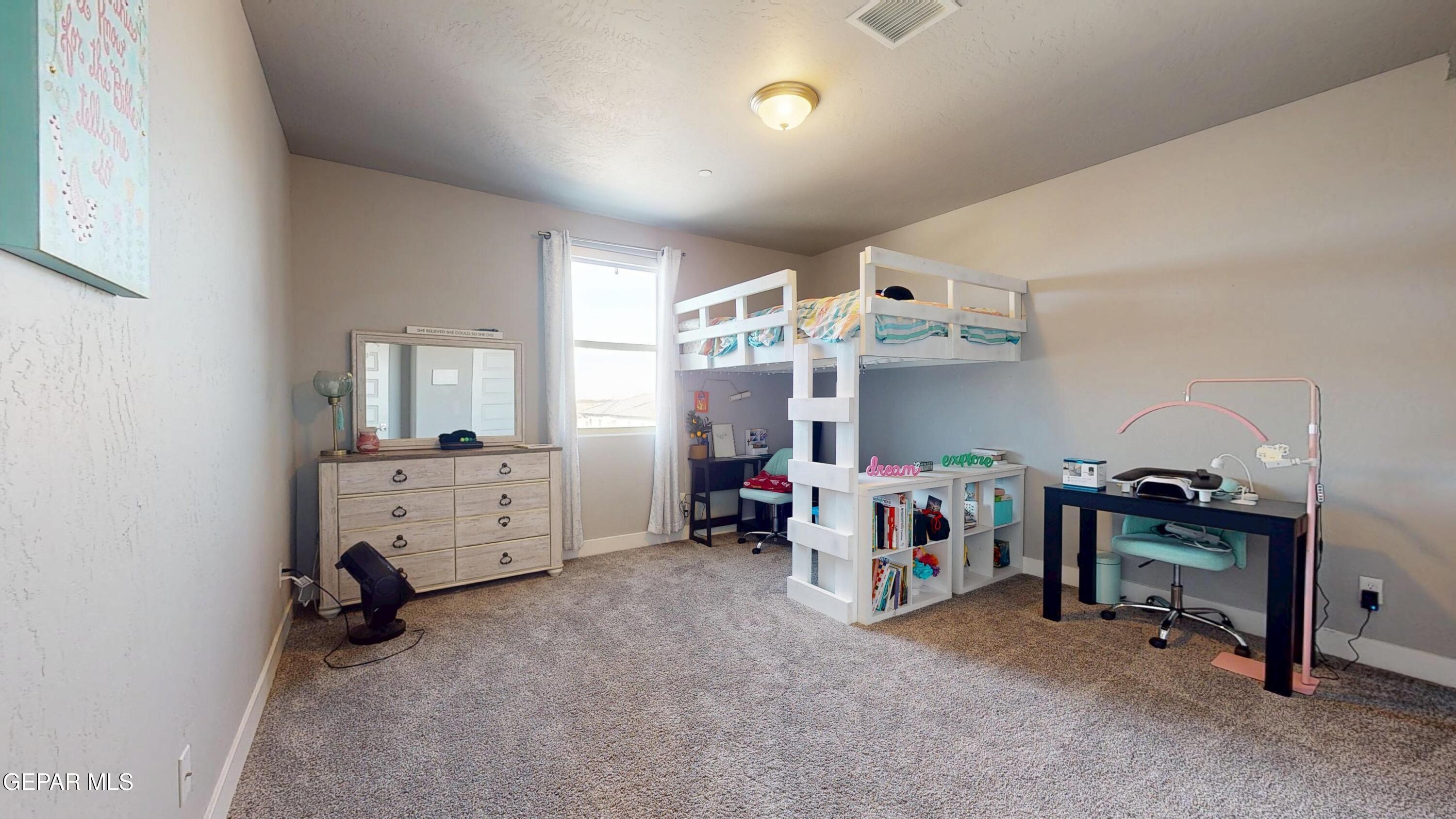 2300 Rory Way El Paso, TX 79911 - Photo 51 of 76 a view of a bedroom with workspace and windows