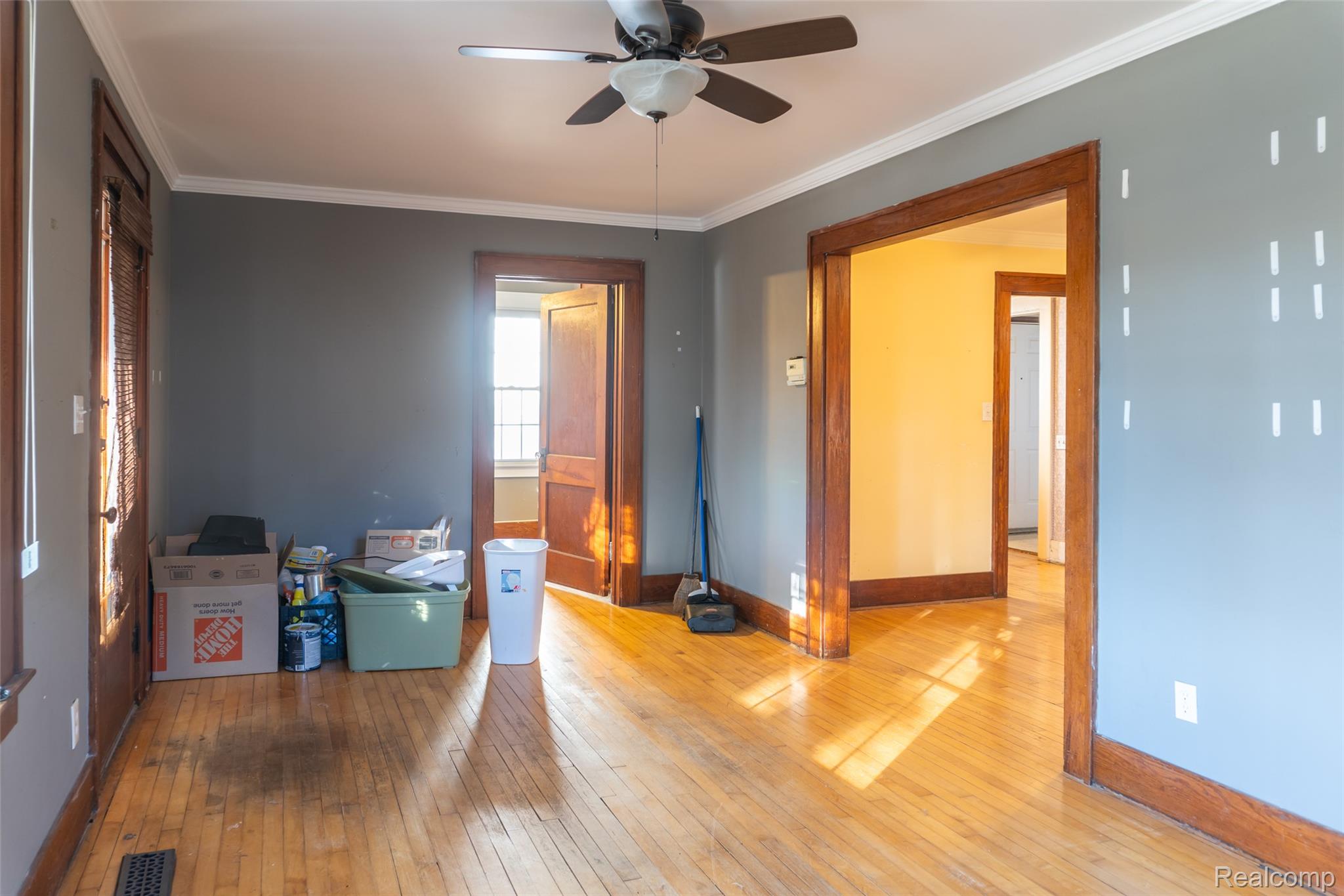 1846 North Gulley Road Dearborn, MI 48128 - Photo 6 of 32 Spare room with crown molding, hardwood / wood-style flooring, and a ceiling fan