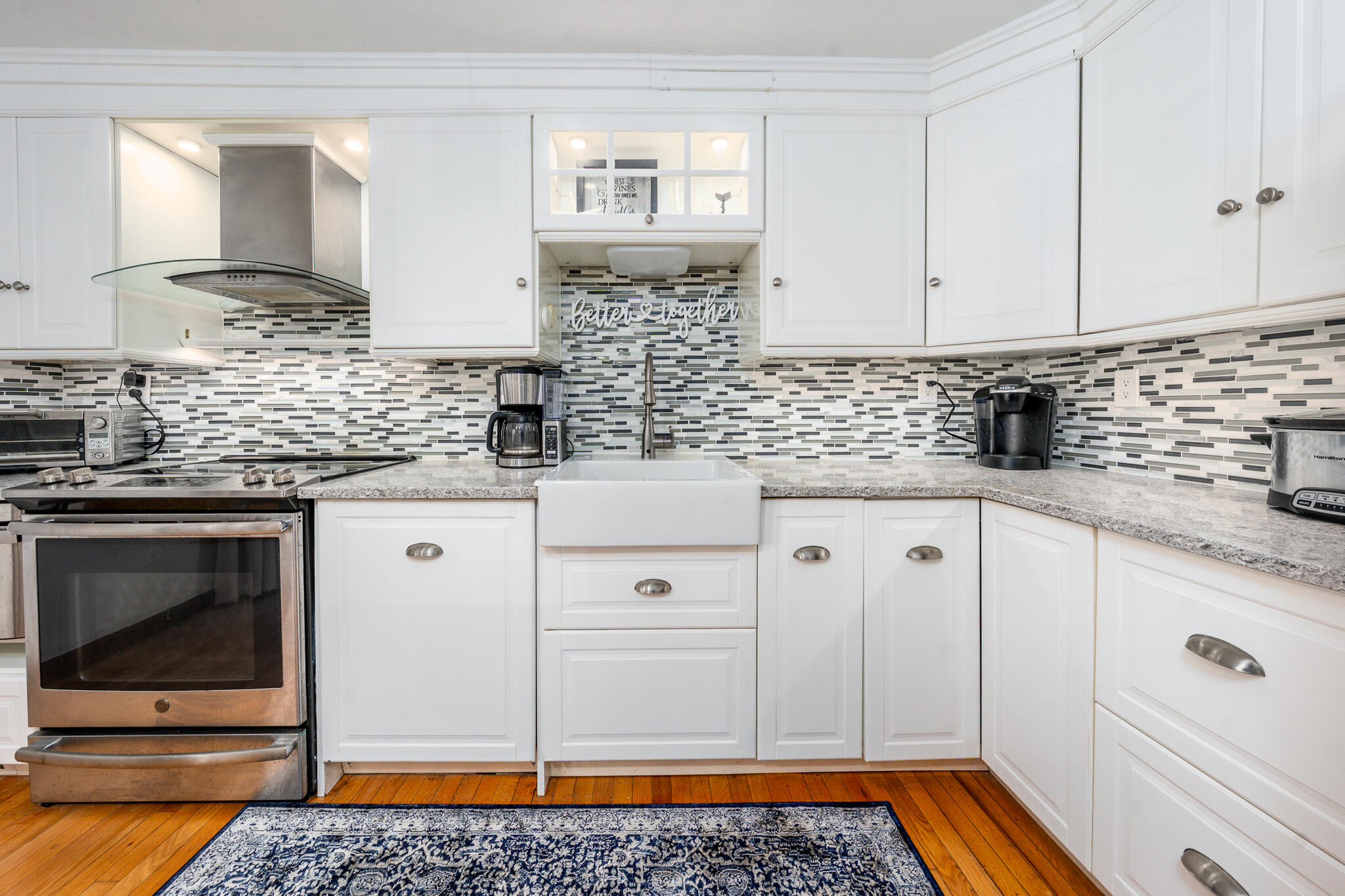 195 Falmouth Road, Unit 9D Mashpee, MA 02649 - Photo 11 of 36 a kitchen with stainless steel appliances granite countertop a stove a sink and a microwave