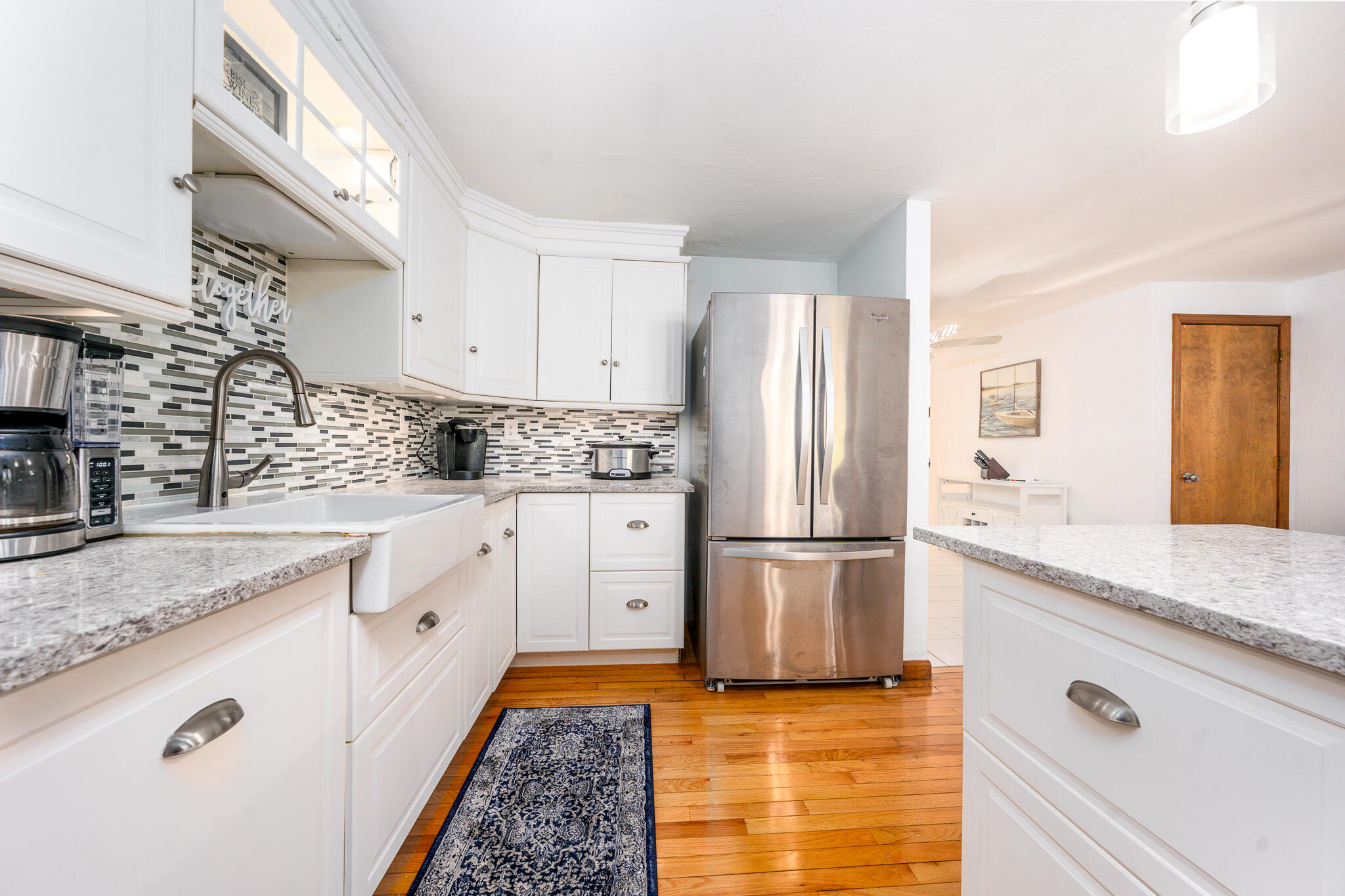 195 Falmouth Road, Unit 9D Mashpee, MA 02649 - Photo 12 of 36 a kitchen with granite countertop cabinets and refrigerator