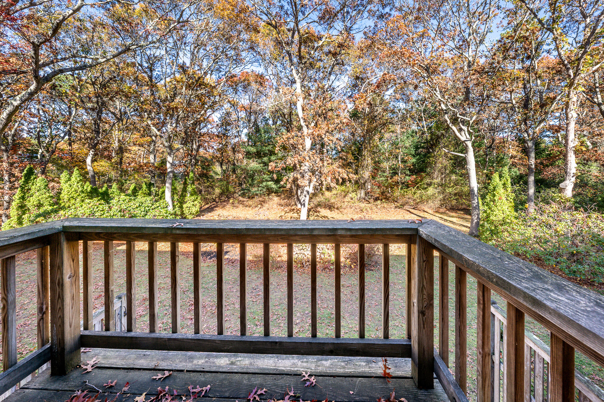 195 Falmouth Road, Unit 9D Mashpee, MA 02649 - Photo 21 of 36 a balcony with wooden floor and fence
