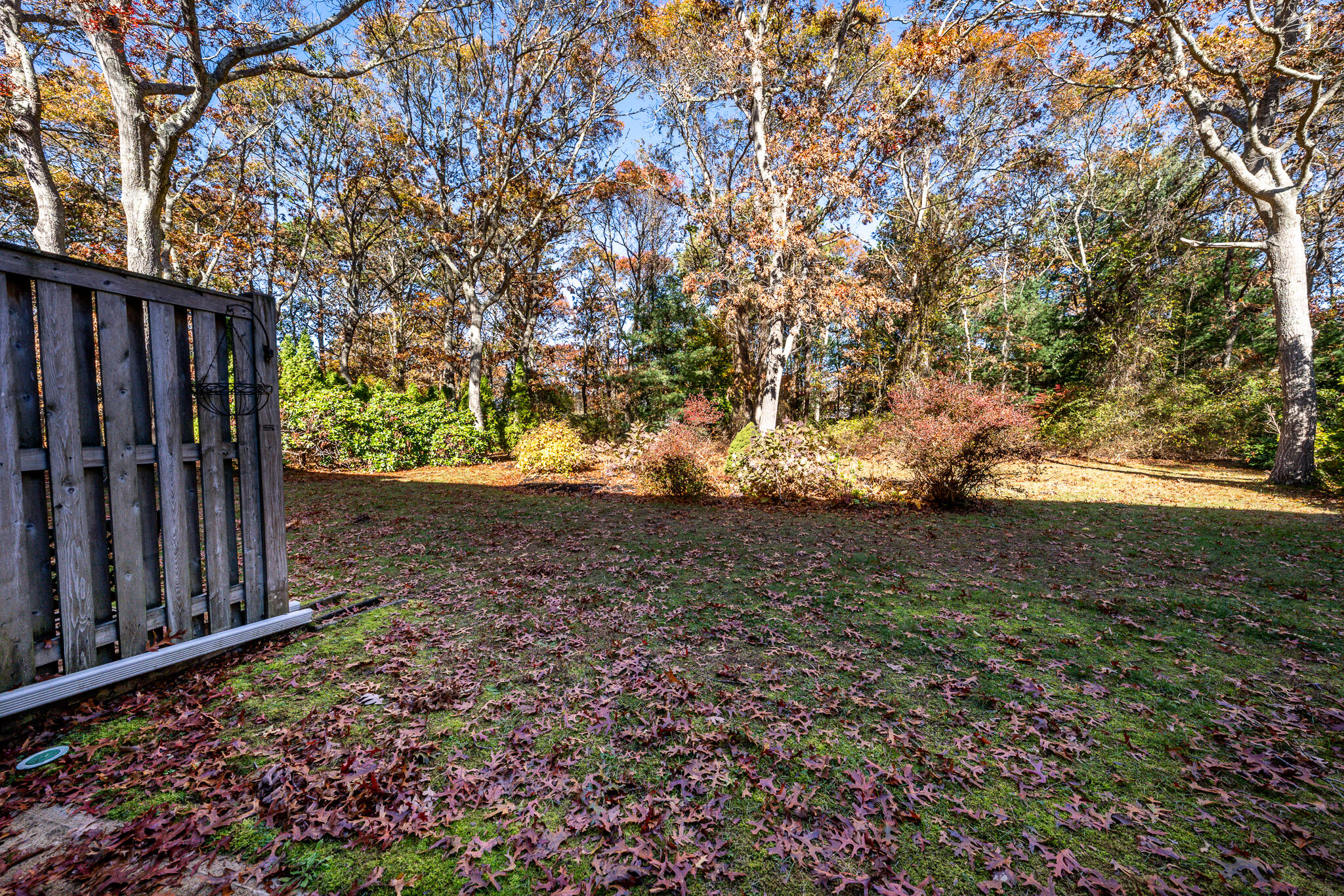 195 Falmouth Road, Unit 9D Mashpee, MA 02649 - Photo 28 of 36 a view of a yard with wooden fence