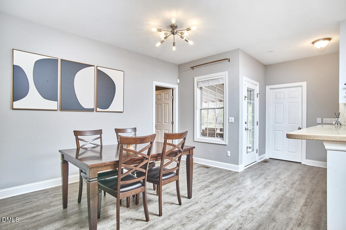 3821 La Costa Way Raleigh, NC 27610 - Photo 11 of 45 a view of a dining room with furniture and wooden floor