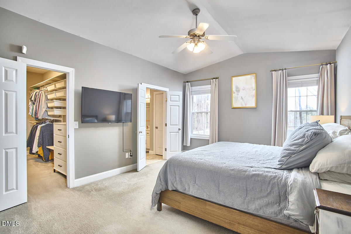 3821 La Costa Way Raleigh, NC 27610 - Photo 15 of 45 a bedroom with a bed and a chandelier