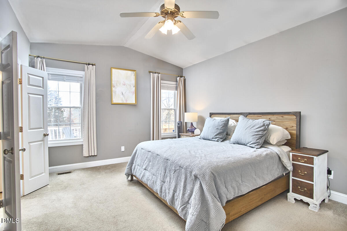 3821 La Costa Way Raleigh, NC 27610 - Photo 16 of 45 a bedroom with a bed and a chandelier