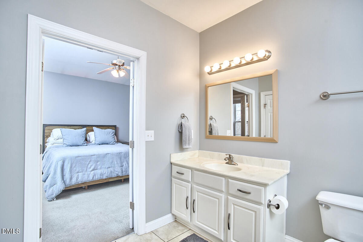 3821 La Costa Way Raleigh, NC 27610 - Photo 18 of 45 a en suite bathroom with a double vanity sink and a mirror