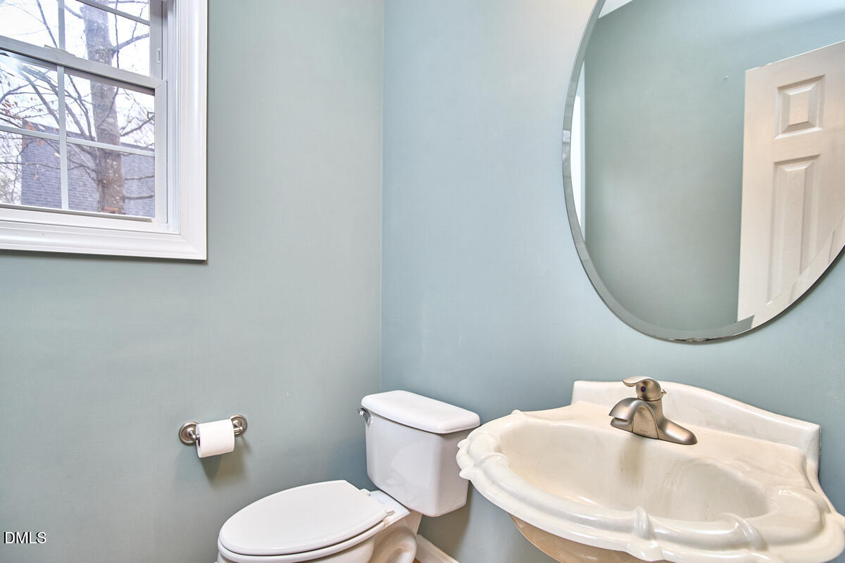 3821 La Costa Way Raleigh, NC 27610 - Photo 20 of 45 a bathroom with a toilet a sink and mirror
