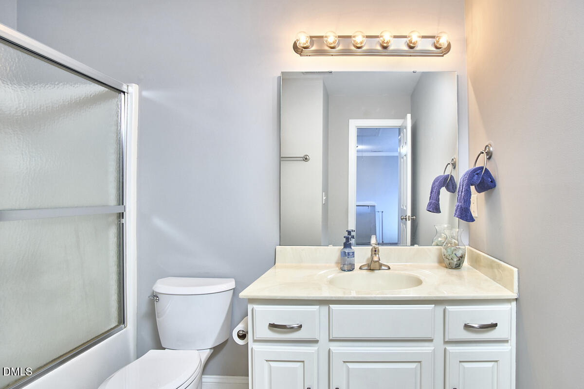 3821 La Costa Way Raleigh, NC 27610 - Photo 28 of 45 a bathroom with a sink vanity mirror and toilet