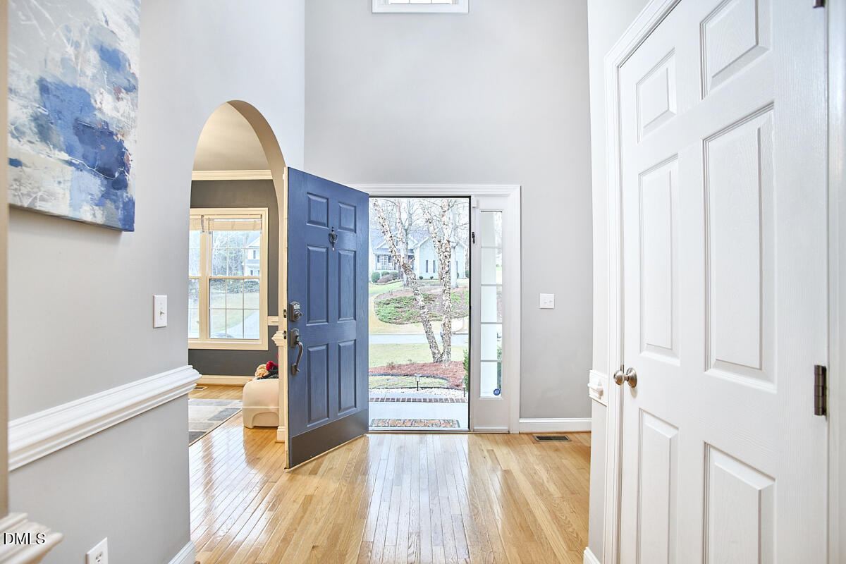 3821 La Costa Way Raleigh, NC 27610 - Photo 5 of 45 a view of a hallway with wooden floor and windows