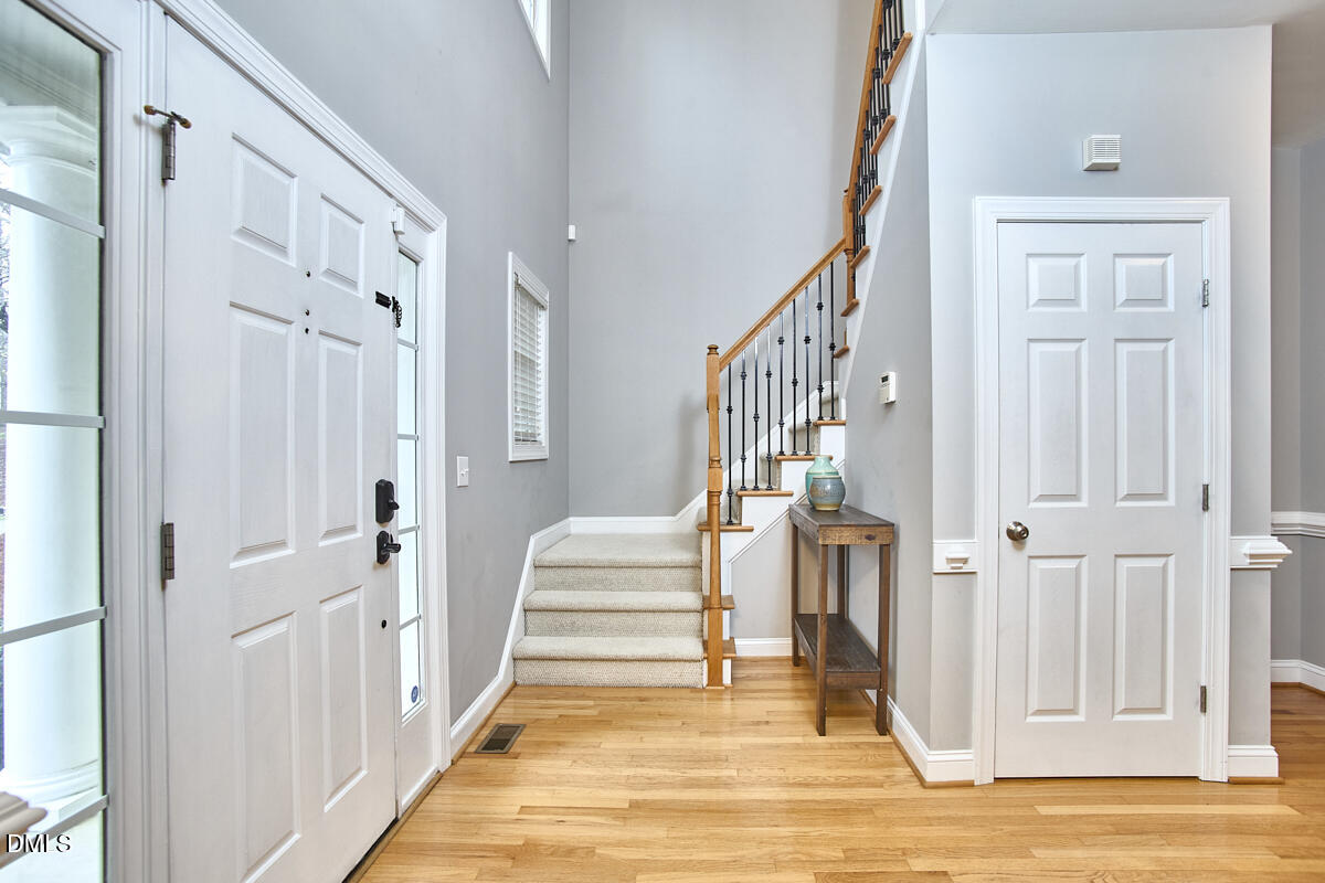 3821 La Costa Way Raleigh, NC 27610 - Photo 6 of 45 a view of a hallway with a livingroom and stairs