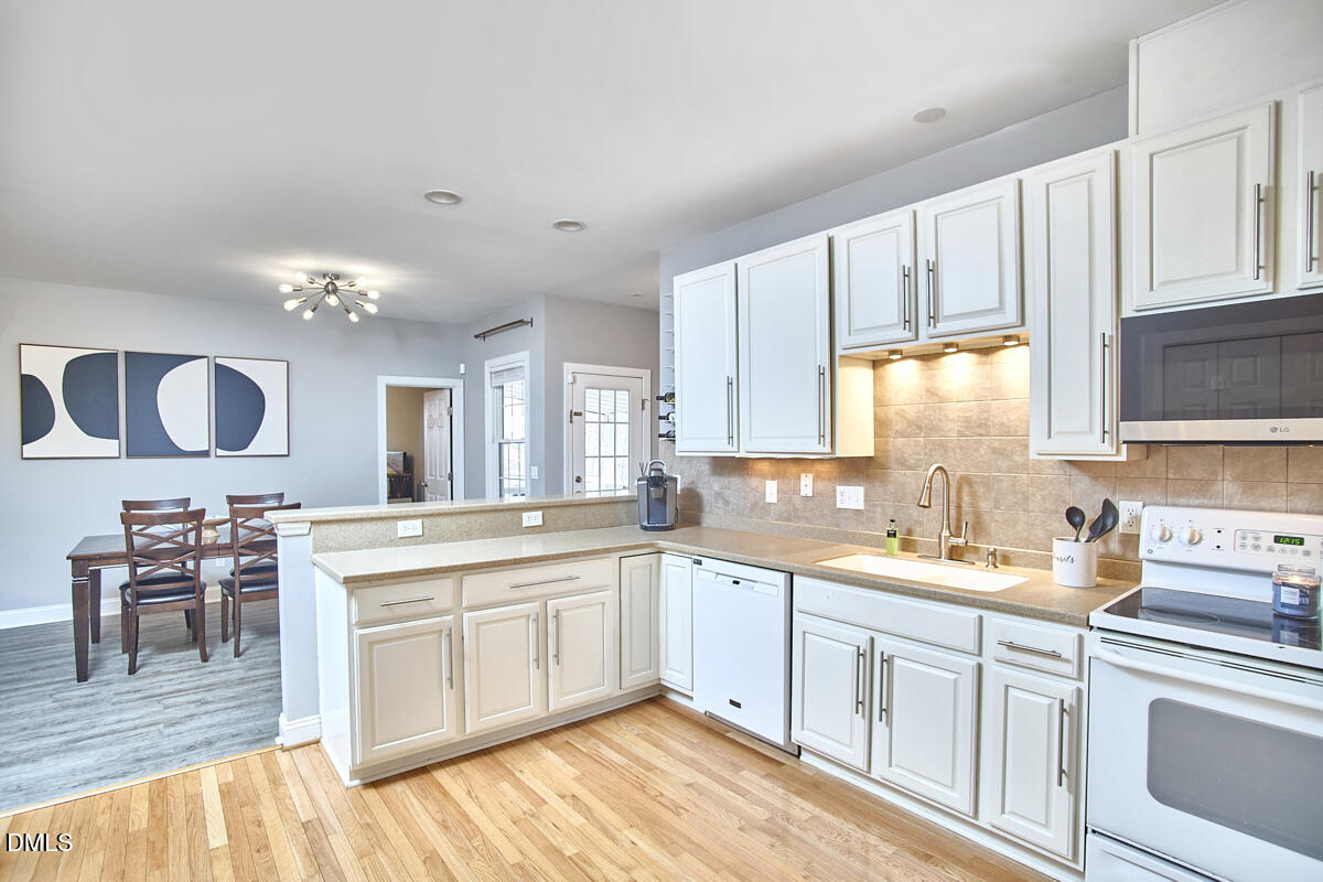 3821 La Costa Way Raleigh, NC 27610 - Photo 8 of 45 a kitchen with a sink stove and cabinets