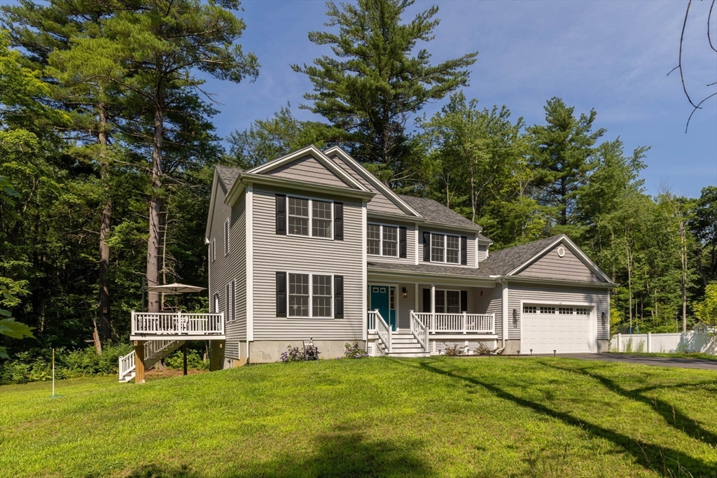 62 Benjamin Road Shirley, MA 01464 - Photo 2 of 37 a front view of a house with a garden