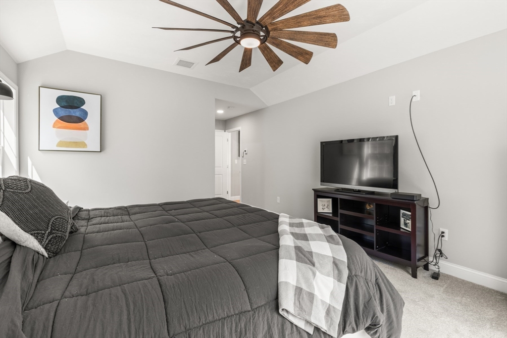 62 Benjamin Road Shirley, MA 01464 - Photo 24 of 37 a bedroom with a bed and a flat screen tv