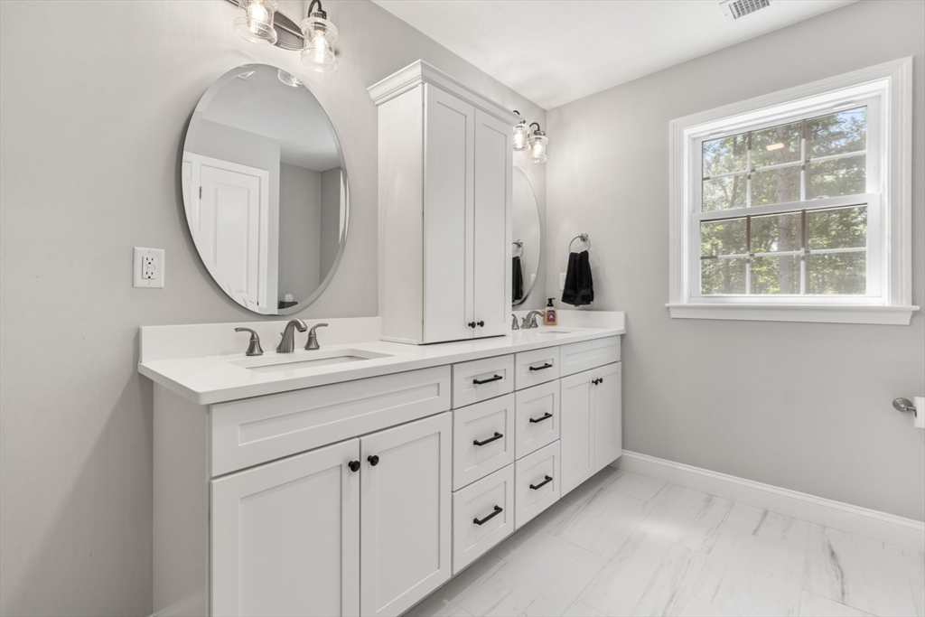62 Benjamin Road Shirley, MA 01464 - Photo 25 of 37 a bathroom with a double vanity sink and a mirror