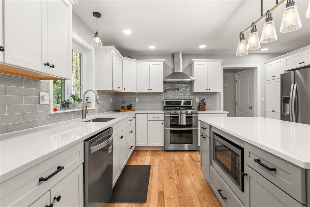 62 Benjamin Road Shirley, MA 01464 - Photo 7 of 37 a kitchen with stainless steel appliances granite countertop a sink a stove and a refrigerator