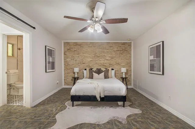 a bedroom with a bed and painting on the wall